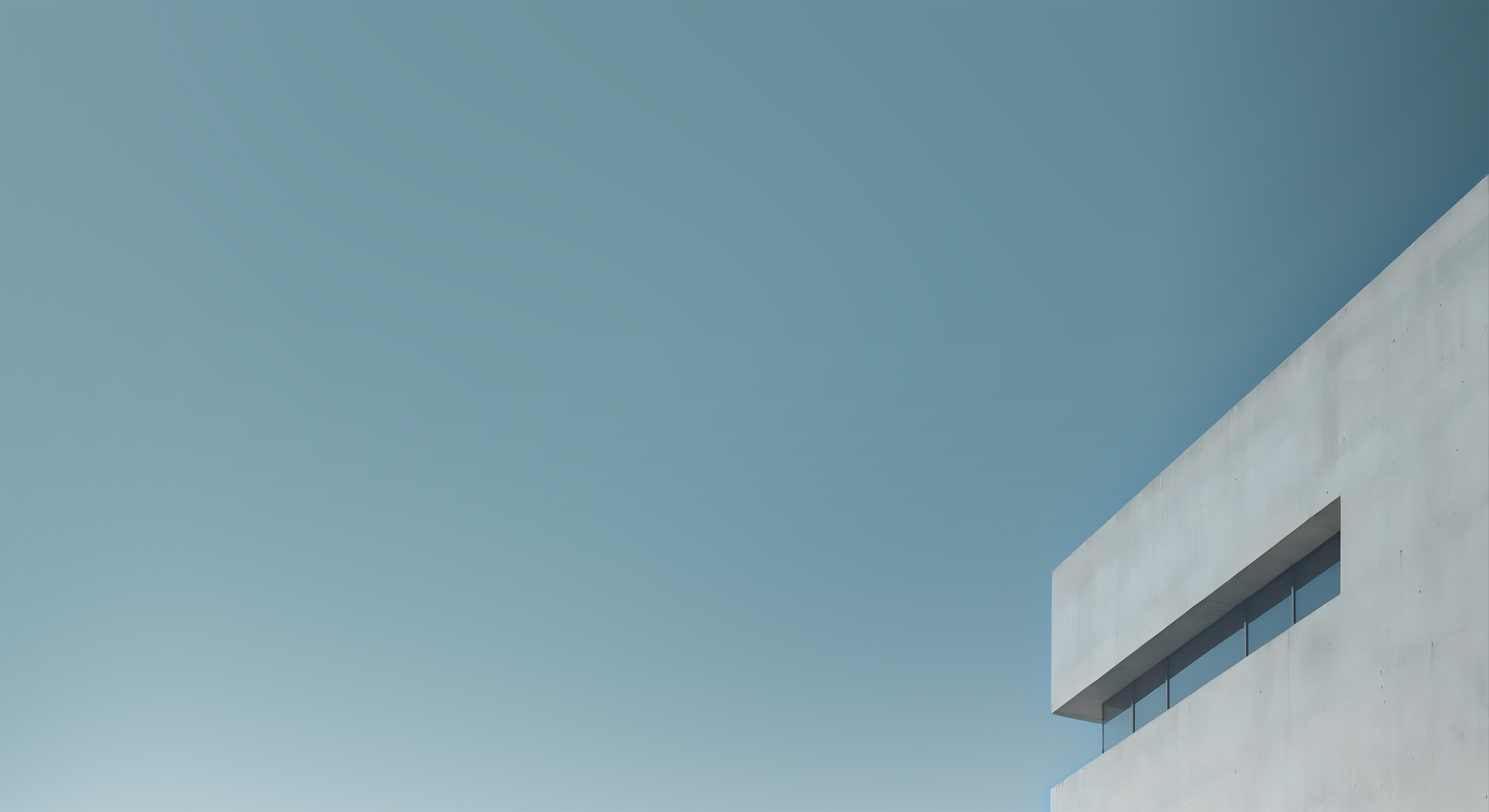 Architectural building corner against a bright sky.